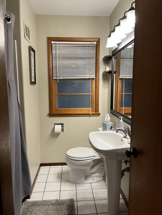 bathroom featuring toilet and tile patterned floors