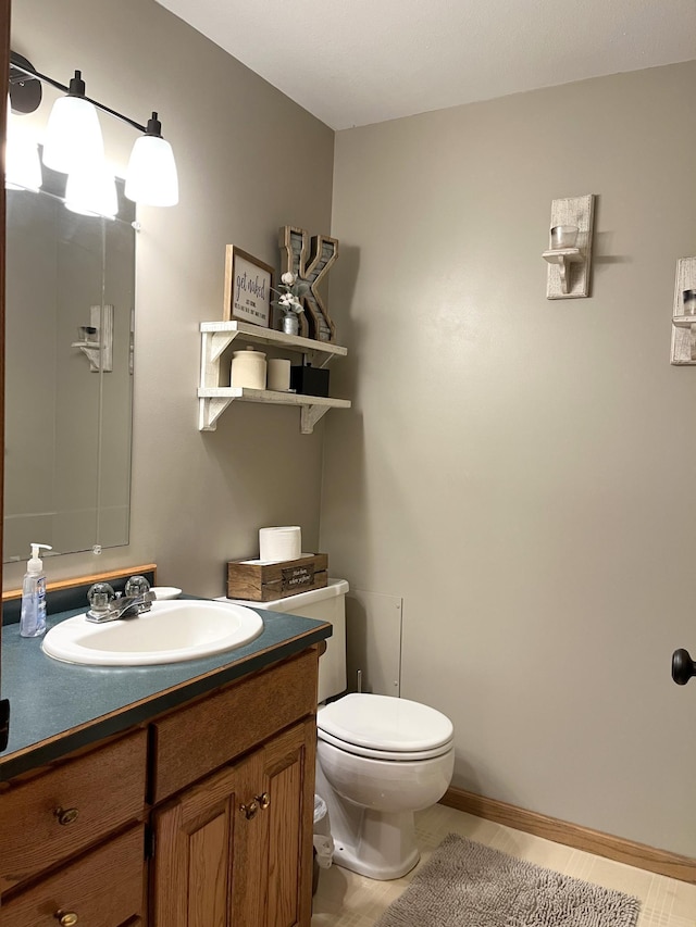 bathroom featuring toilet and vanity