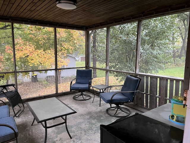 unfurnished sunroom with wooden ceiling and a wealth of natural light