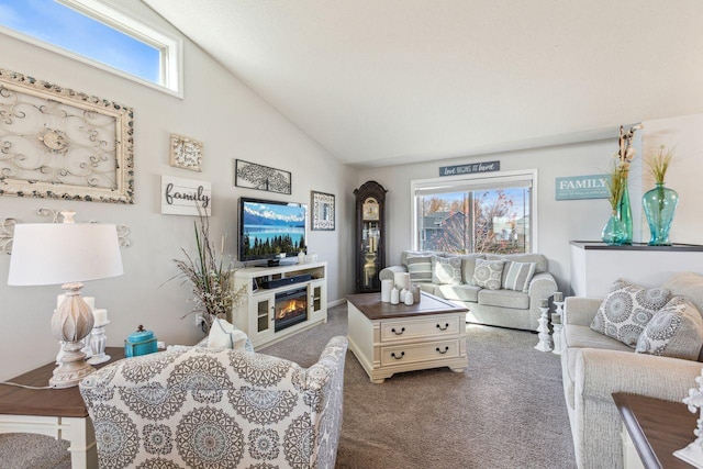 living room with high vaulted ceiling, a healthy amount of sunlight, carpet floors, and a fireplace