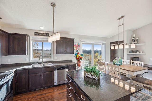 kitchen with dark wood-type flooring, appliances with stainless steel finishes, sink, and pendant lighting