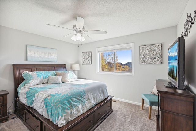 carpeted bedroom with ceiling fan and a textured ceiling