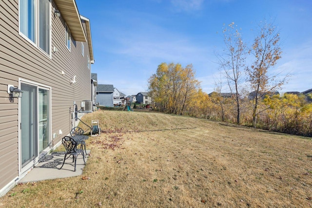 view of yard with a patio and central AC unit