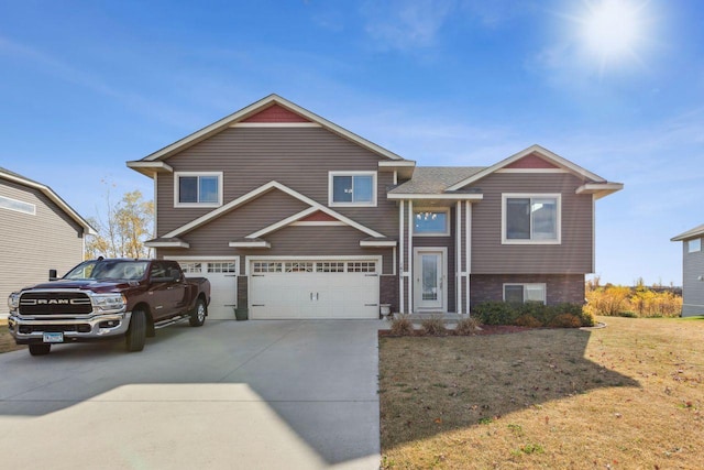 view of front facade featuring a front yard and a garage