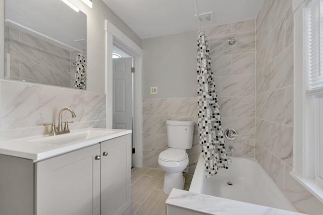 full bathroom with vanity, toilet, shower / bathtub combination with curtain, and tile walls