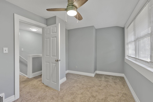 unfurnished bedroom featuring ceiling fan and light colored carpet