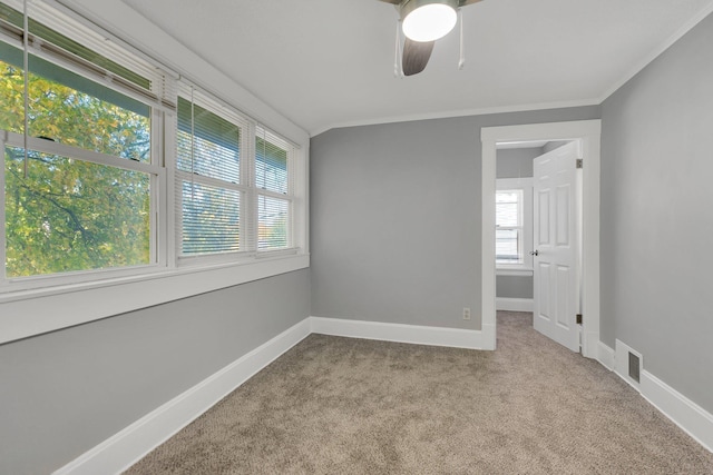 carpeted spare room with crown molding and ceiling fan