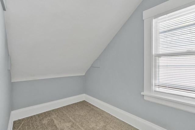 bonus room with carpet, vaulted ceiling, and a wealth of natural light