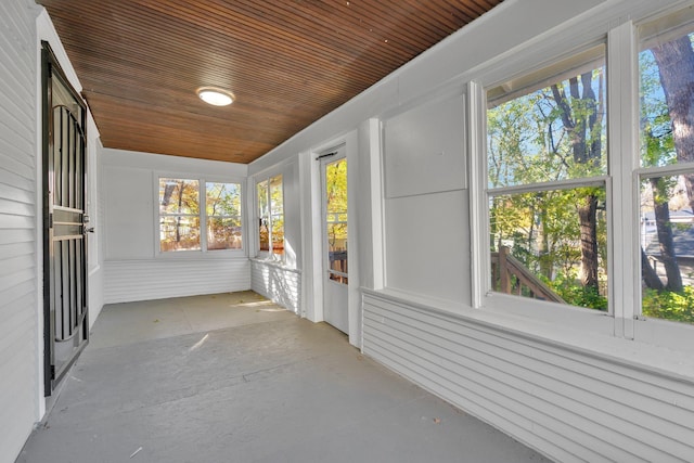 unfurnished sunroom with wooden ceiling