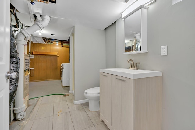 bathroom featuring vanity, toilet, washer / dryer, and tile patterned flooring