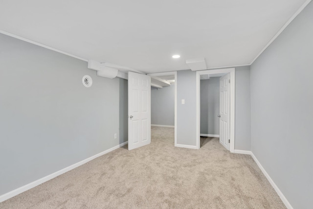 basement featuring crown molding and light colored carpet