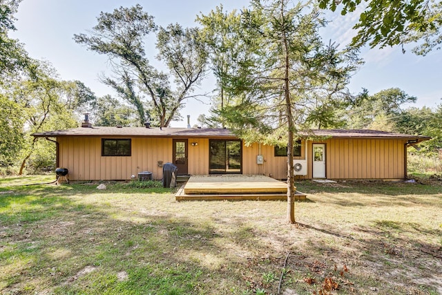 rear view of house featuring a yard and central AC