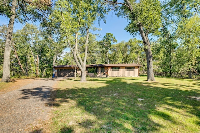 view of front of property with a garage and a front lawn