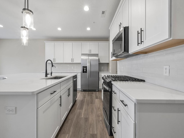 kitchen with pendant lighting, sink, white cabinetry, and stainless steel appliances