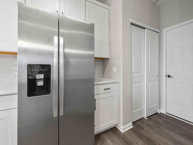 kitchen featuring stainless steel refrigerator with ice dispenser, white cabinetry, and dark wood-type flooring