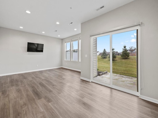 unfurnished living room featuring light wood-type flooring and plenty of natural light