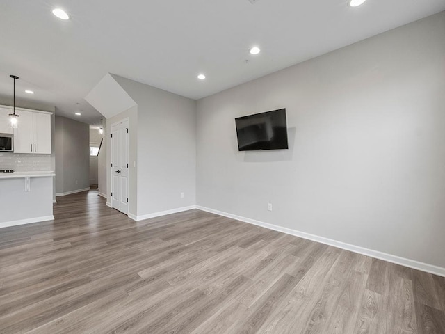 unfurnished living room featuring light wood-type flooring