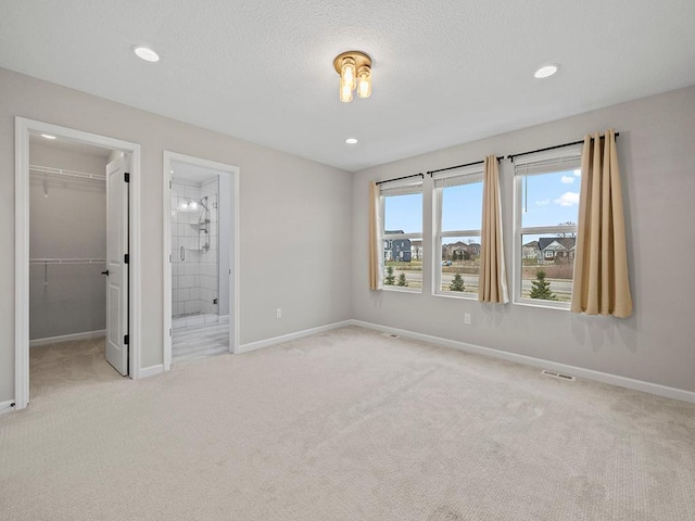 carpeted spare room with a textured ceiling