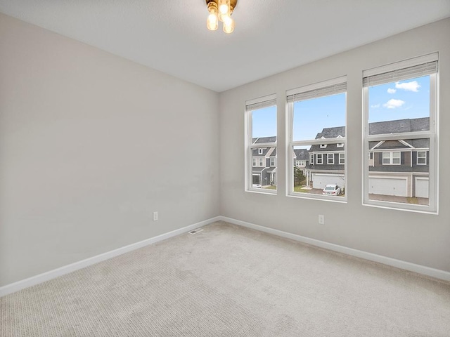 carpeted empty room with a healthy amount of sunlight