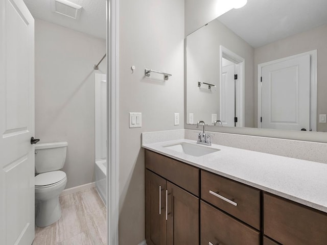 full bathroom featuring shower / washtub combination, vanity, and toilet