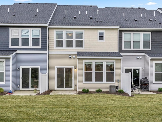 back of property featuring a yard, a patio, and central AC