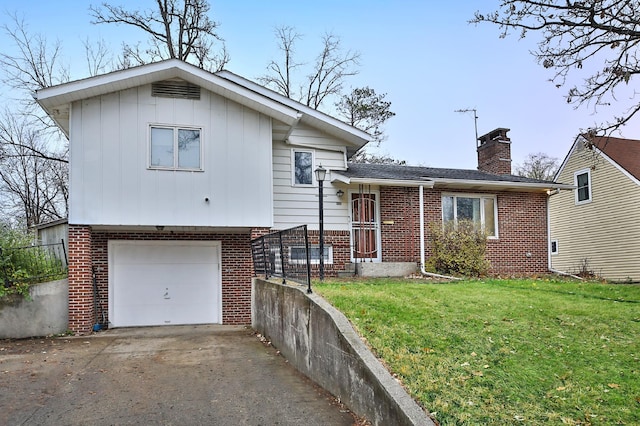 tri-level home with a garage and a front lawn