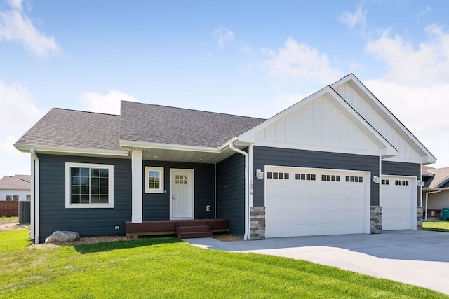 view of front of home featuring a front yard and a garage