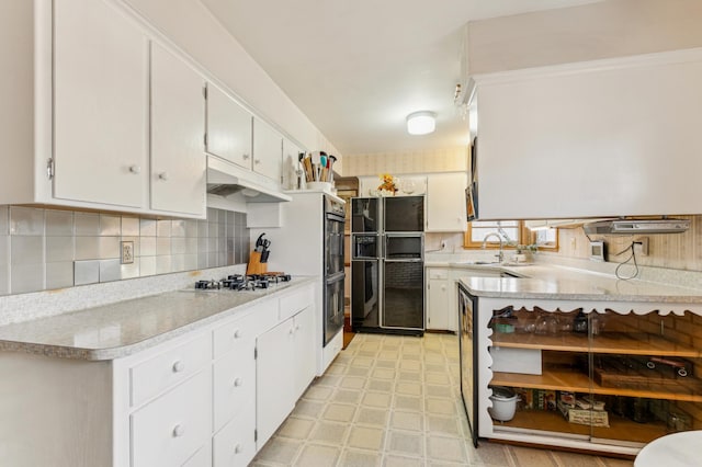 kitchen featuring sink, black refrigerator with ice dispenser, white gas stovetop, white cabinets, and backsplash