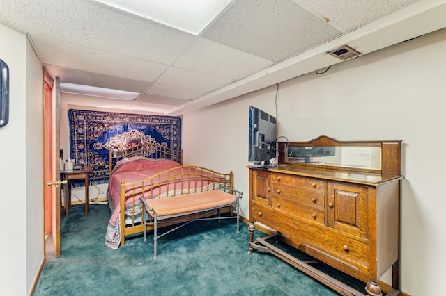 bedroom featuring carpet flooring and a paneled ceiling