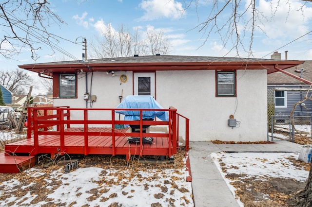 snow covered property featuring a wooden deck