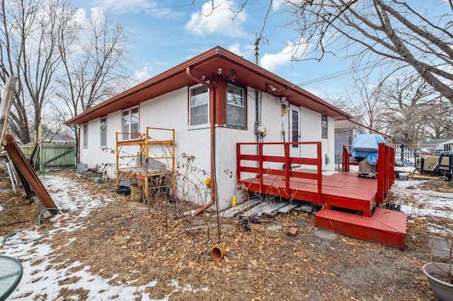 view of snowy exterior featuring a wooden deck