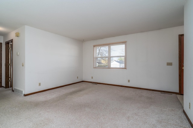 unfurnished room featuring light carpet