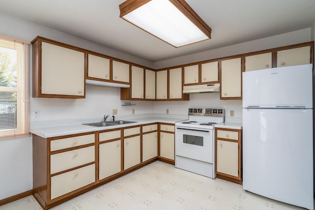 kitchen featuring electric stove, sink, and white fridge