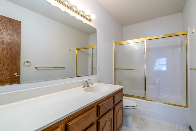 full bathroom with combined bath / shower with glass door, vanity, and toilet