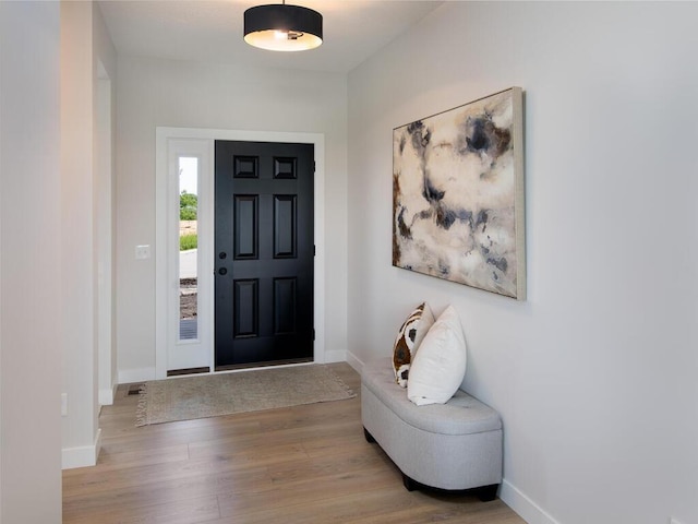 entryway with wood finished floors and baseboards