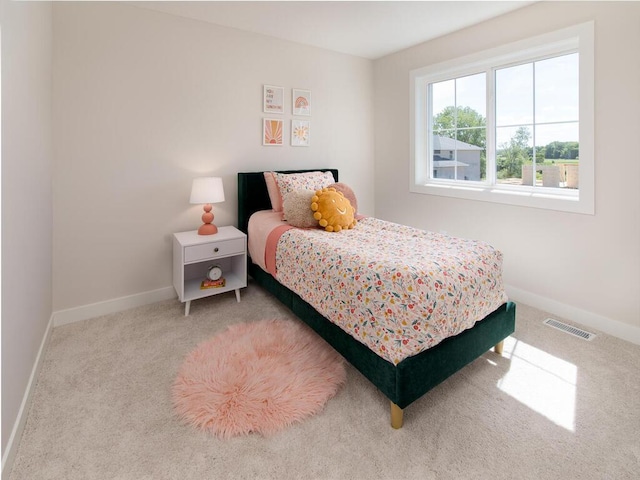 carpeted bedroom with visible vents and baseboards