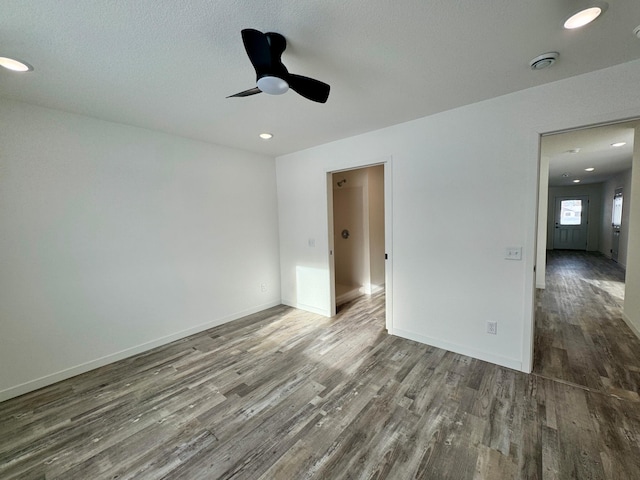 spare room with ceiling fan and dark hardwood / wood-style floors