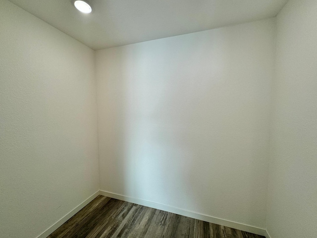 spare room with dark hardwood / wood-style floors