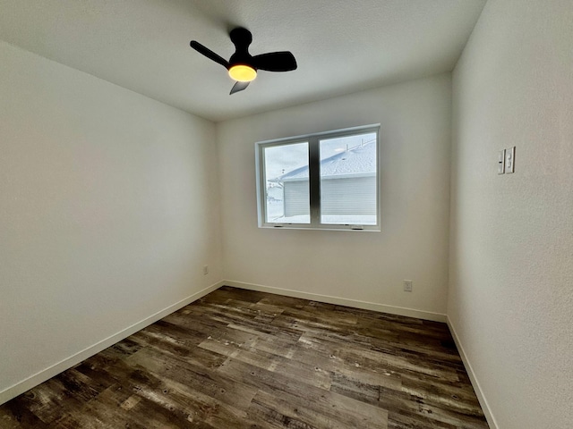 unfurnished room with dark wood-type flooring and ceiling fan