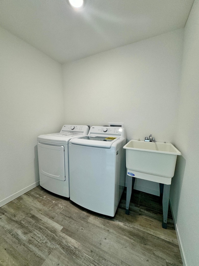 washroom featuring washer and dryer and light hardwood / wood-style flooring