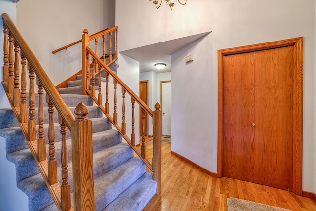 stairway with hardwood / wood-style flooring