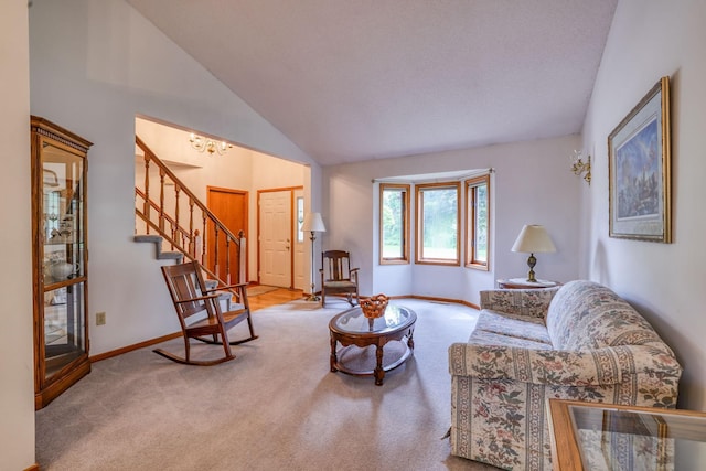 carpeted living room with high vaulted ceiling