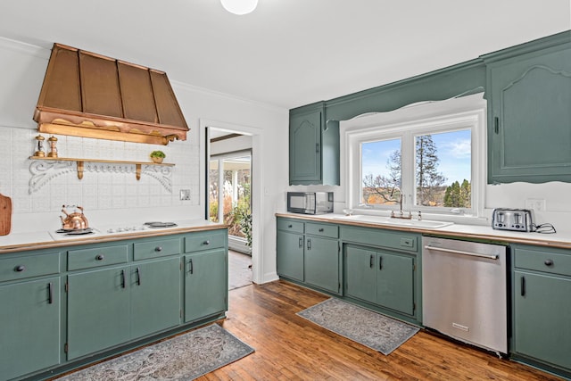 kitchen with a sink, custom exhaust hood, black microwave, decorative backsplash, and stainless steel dishwasher