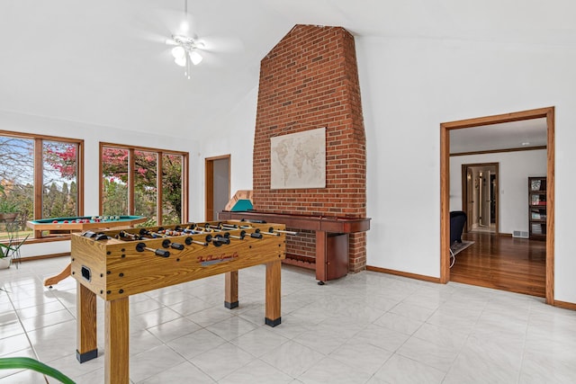 game room with baseboards, ceiling fan, visible vents, and high vaulted ceiling