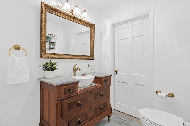half bathroom featuring toilet and vanity