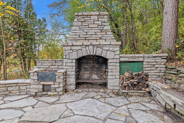 view of patio / terrace featuring an outdoor stone fireplace