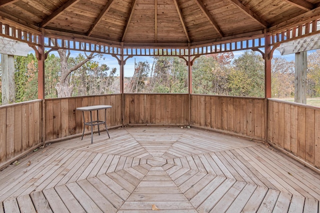 unfurnished sunroom with beam ceiling