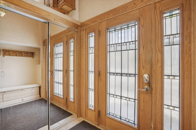 doorway with light colored carpet and a healthy amount of sunlight