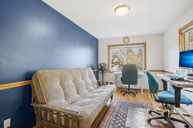 office space with hardwood / wood-style floors and lofted ceiling