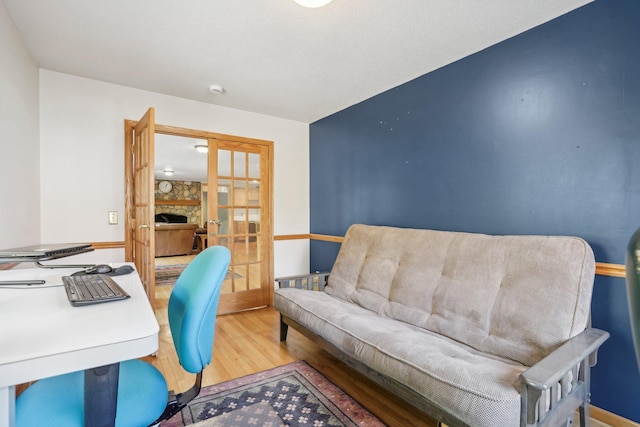 office space with light hardwood / wood-style flooring and french doors